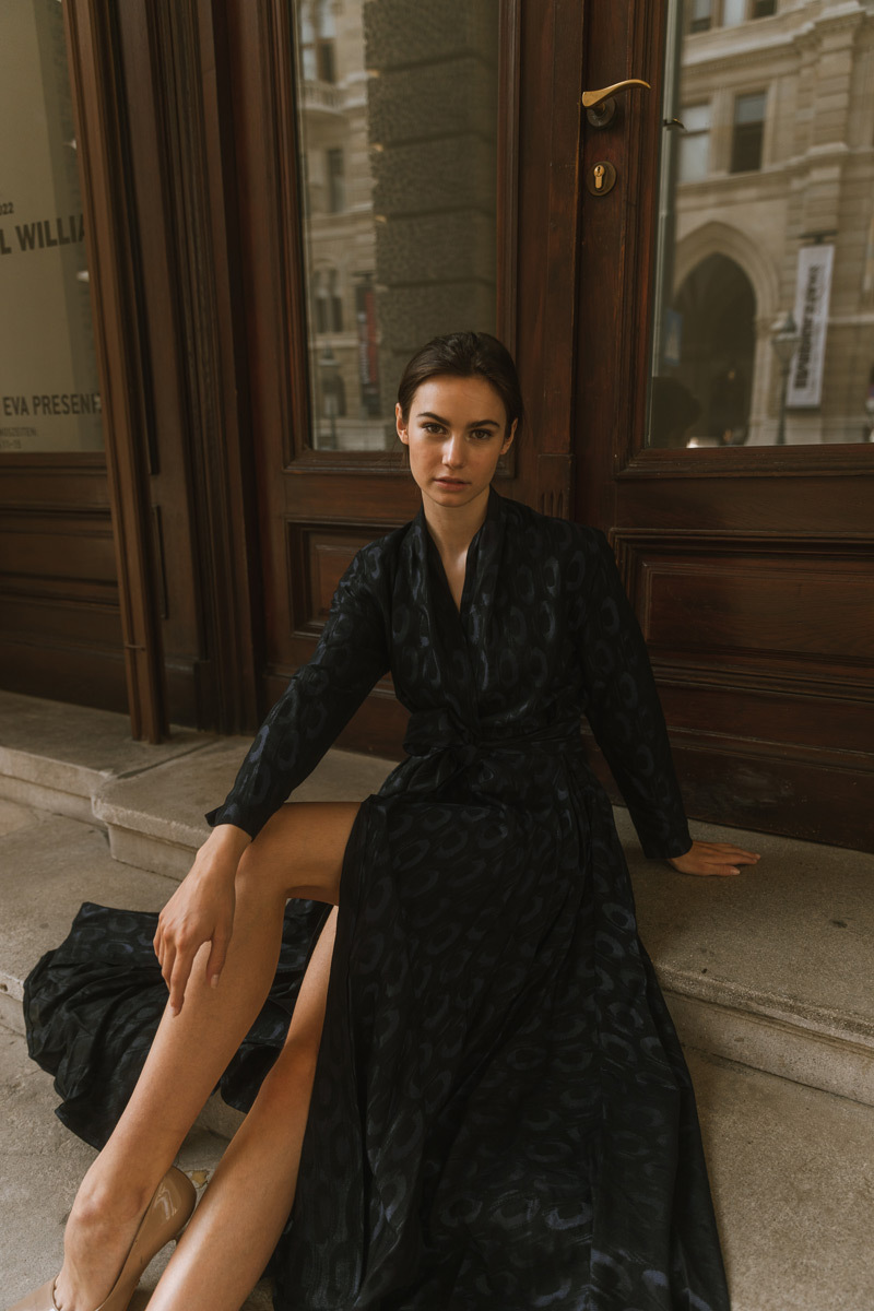 Girl wearing a dress sitting on stairs