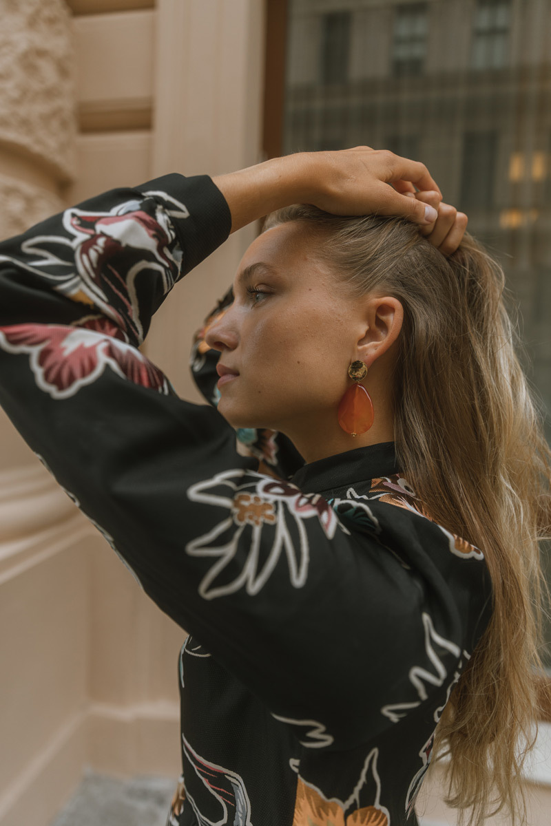 Blonde girl captured from the side, showing off earrings