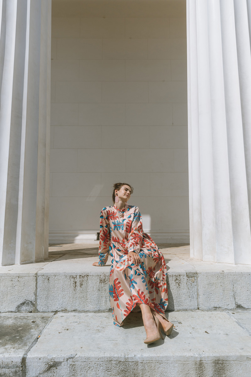 Girl in a dress, sitting on stairs of the Theseustemple in Vienna