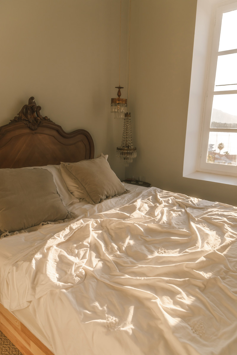 A bed during sunset, white sheets