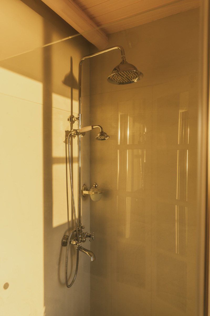 A shower through a glass wall during sunset, golden hour