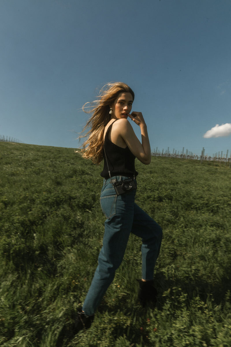 Blurry photo of a blonde girl walking in a field