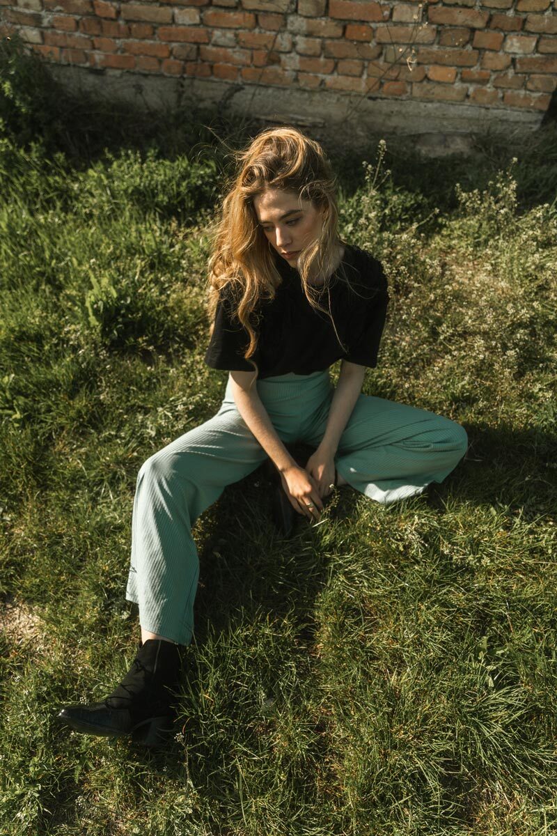 Blonde girl sitting in the grass