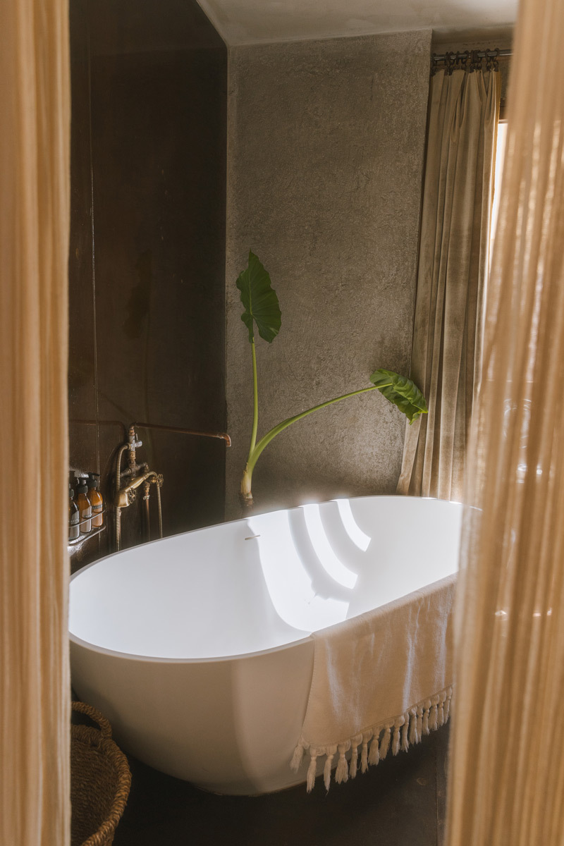 Big bathtub surrounded by curtains