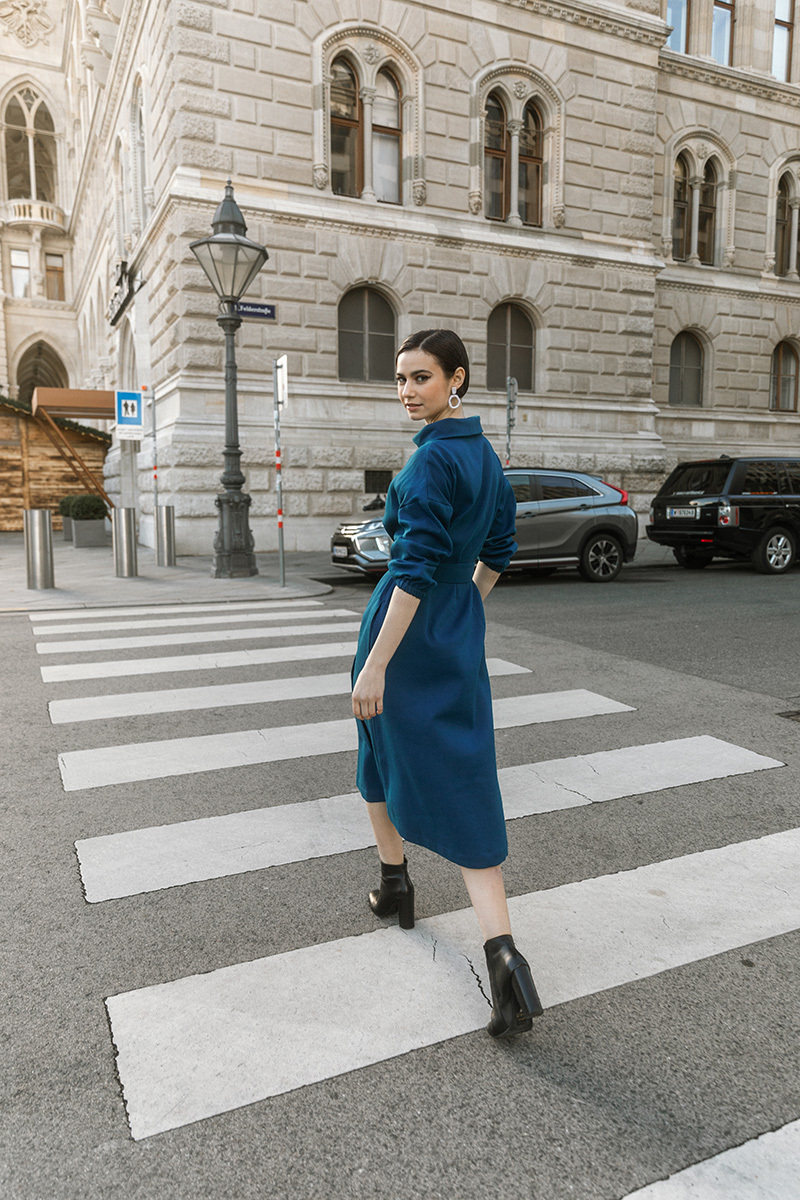 girl in blue dress crossing the street