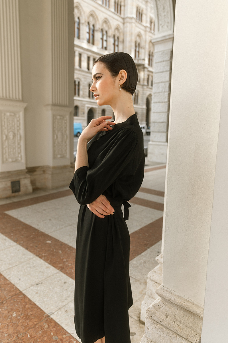 girl in black dress standing in the first district of vienna