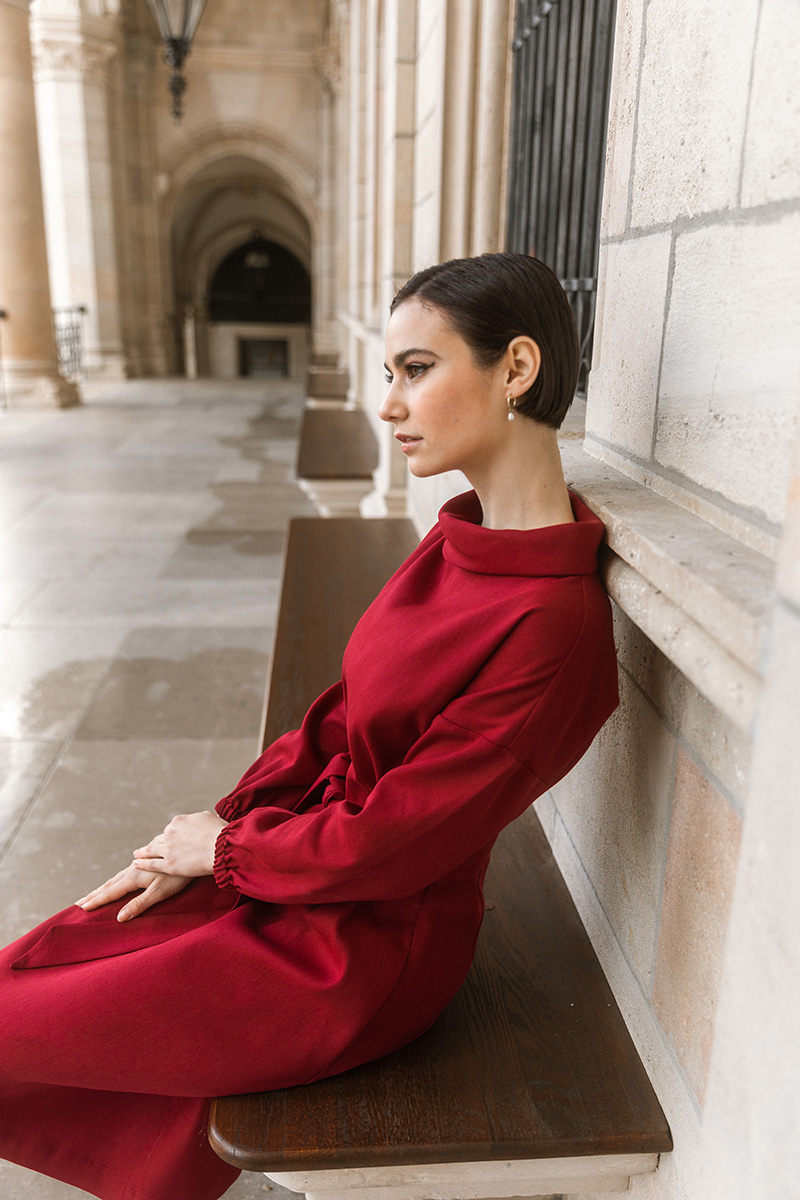 girl in red dress sitting on a bench