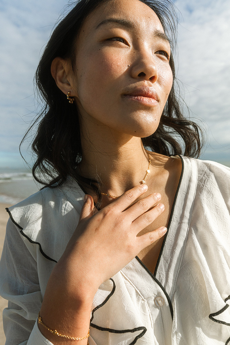 girl with jewellery standing with white blouse