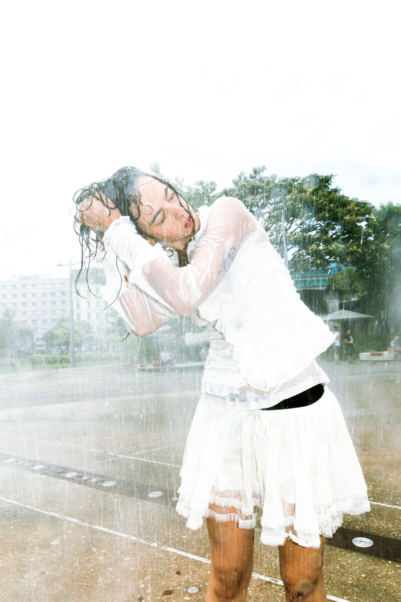 girl with wet hair standing in white clothing