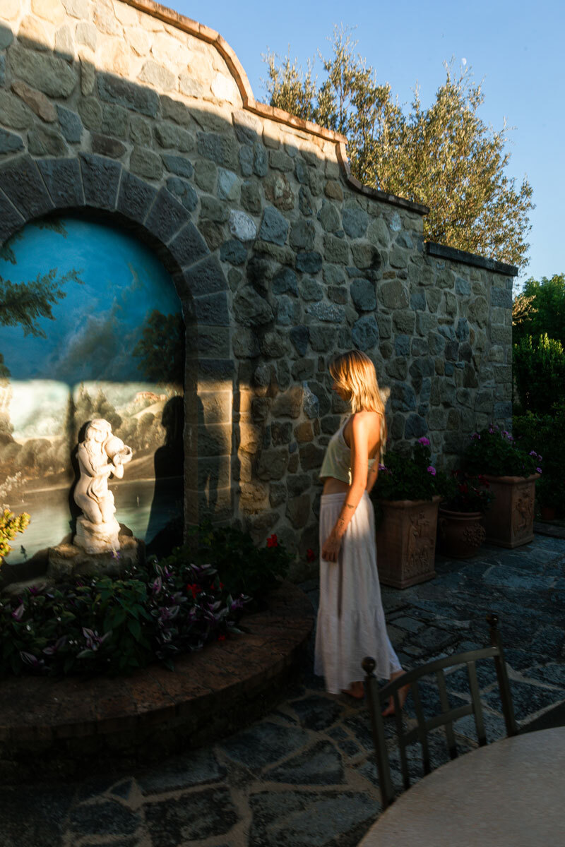 girl standing in front of a fountain