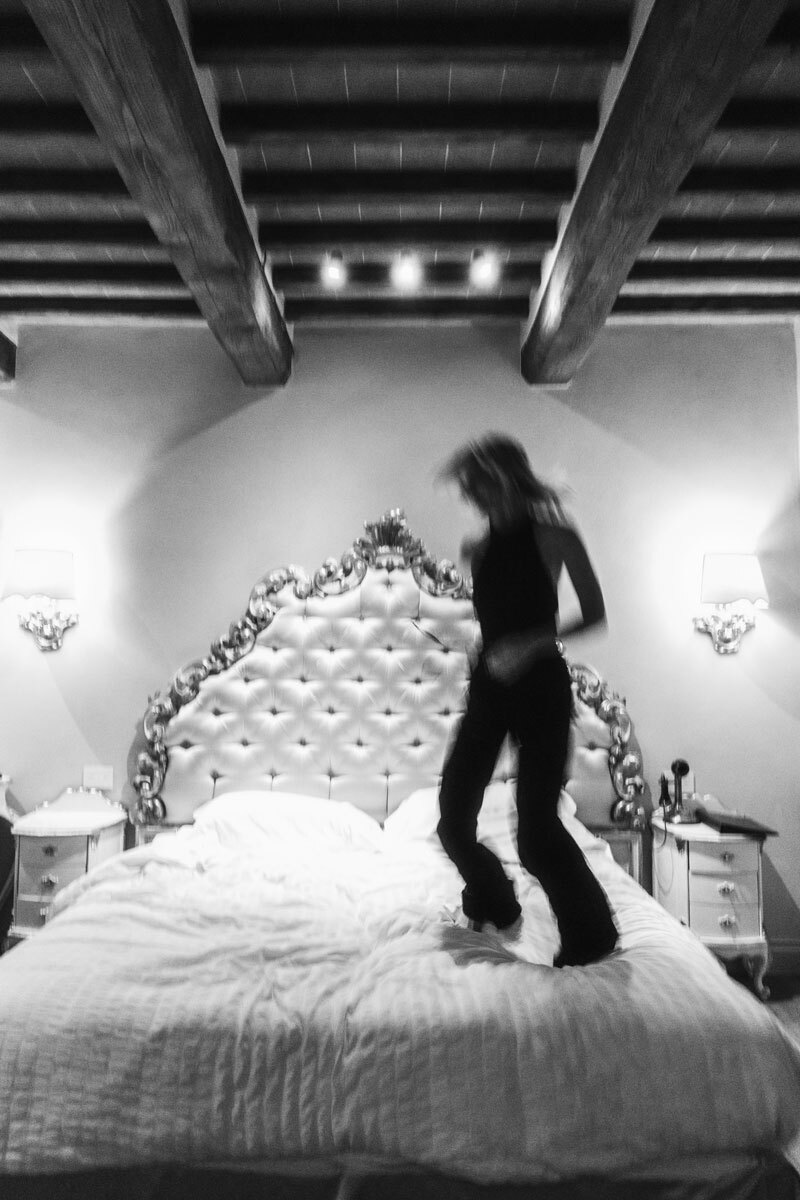 girl jumping on a bed