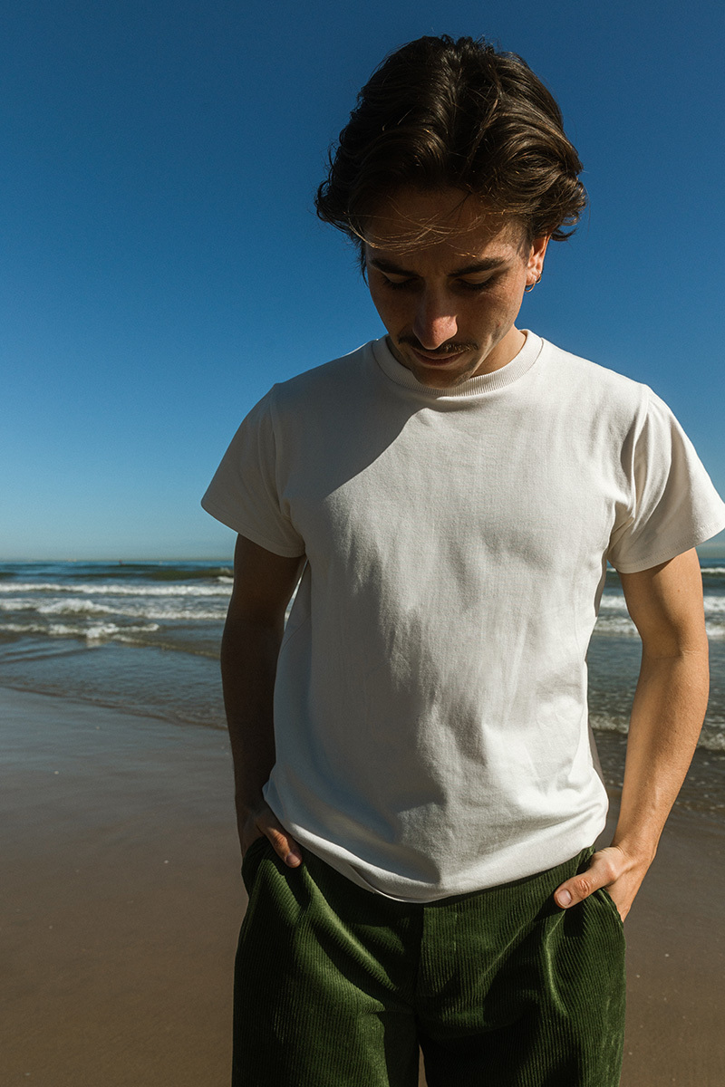 boy standing in front of the ocean