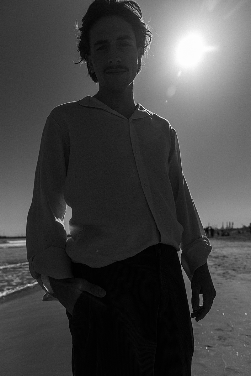 boy standing in front of the ocean