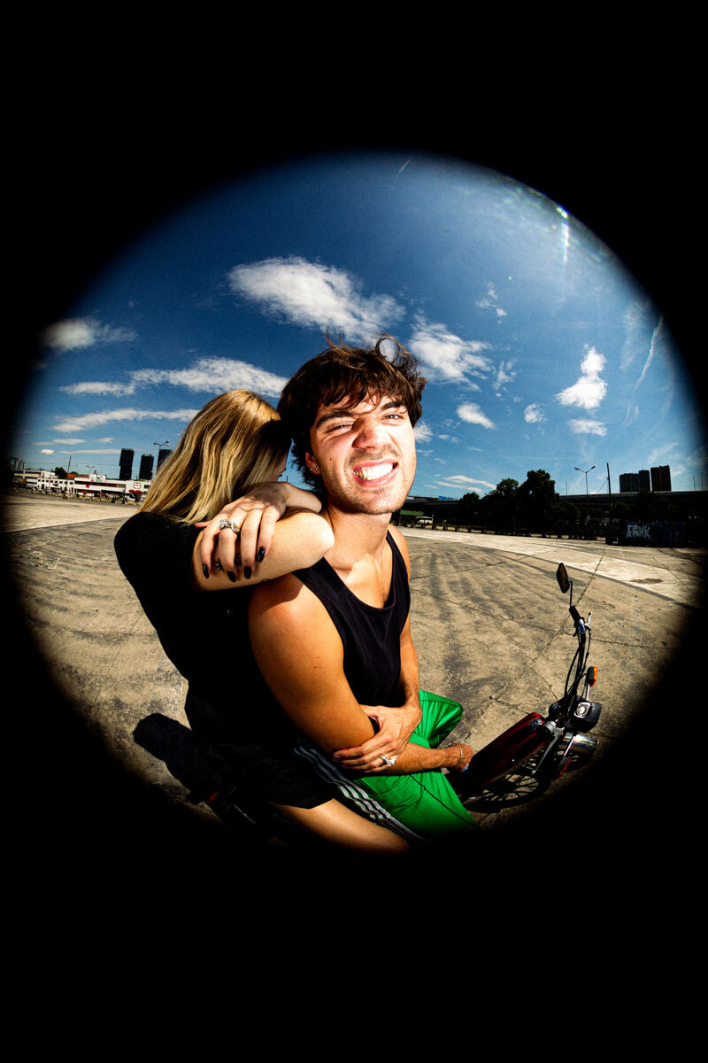 fisheye perspective, boy and girl on a motorcycle