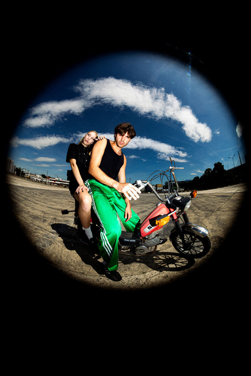 fisheye lens, girl and boy sitting on a motorcycle