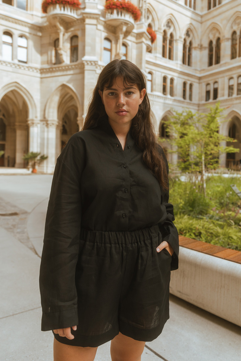 Girl wearing black outfit standing in front of historic building